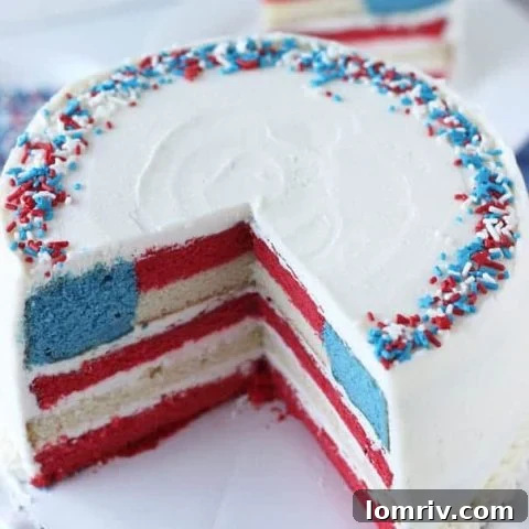 Red white and blue layered flag cake with berries