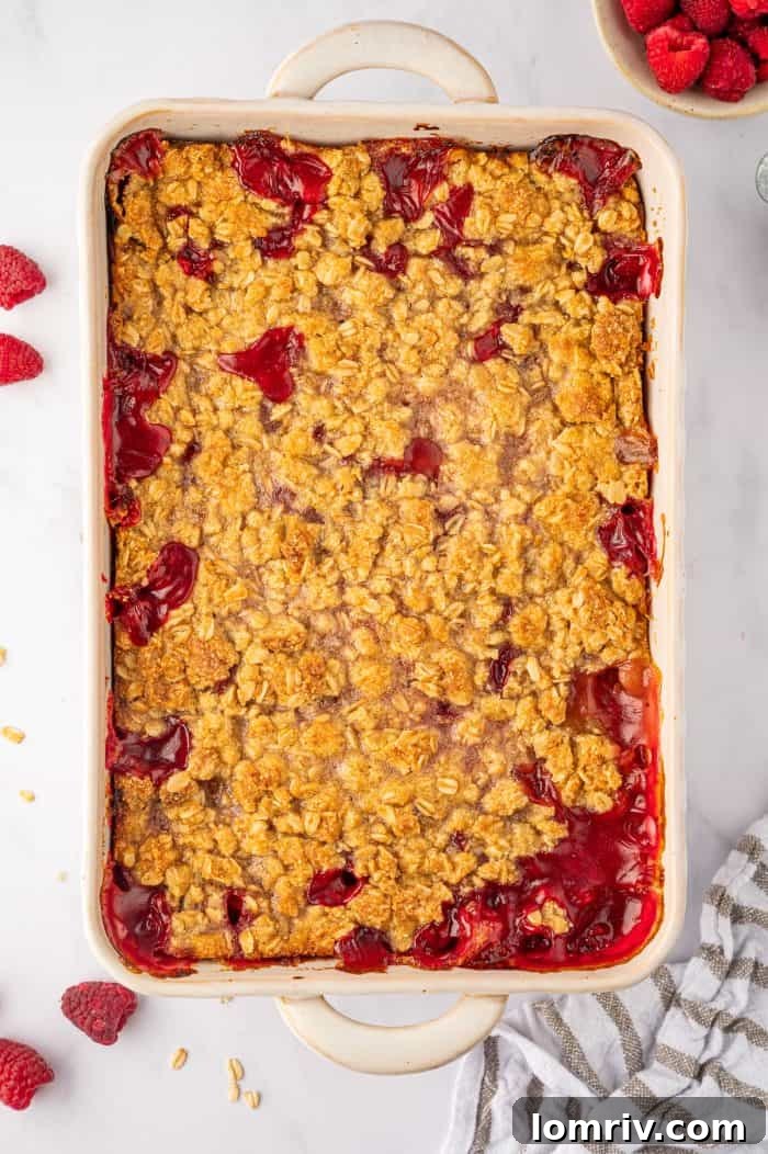 A perfectly baked peach raspberry crumble, golden brown and bubbling, just pulled from the oven and cooling.
