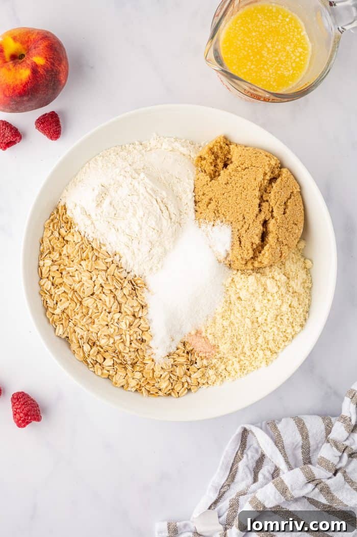 Dry ingredients for the crumble topping: rolled oats, all-purpose flour, almond meal, granulated sugar, brown sugar, cinnamon, and salt, in a mixing bowl.