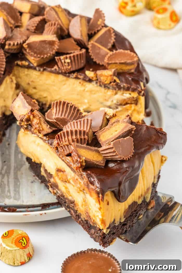 A tantalizing slice of Reese's Peanut Butter Cheesecake being expertly removed from the larger cake, highlighting its rich layers and irresistible appeal.