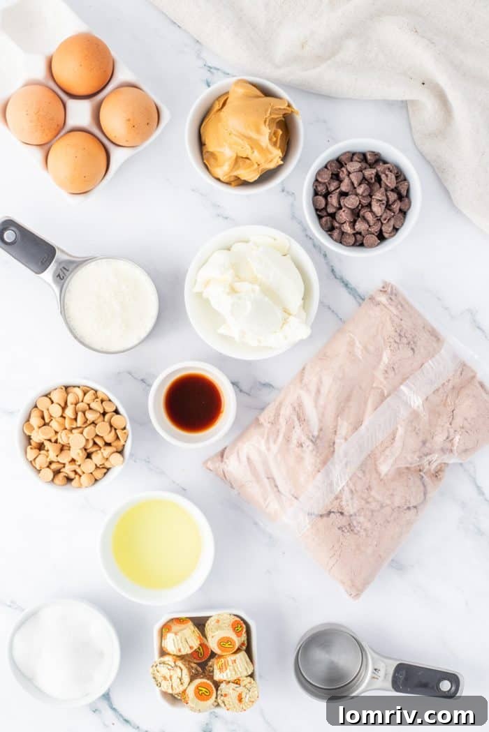 All the key ingredients for Reese's Peanut Butter Cheesecake, neatly arranged in small bowls, including cream cheese, eggs, chocolate chips, and peanut butter cups.