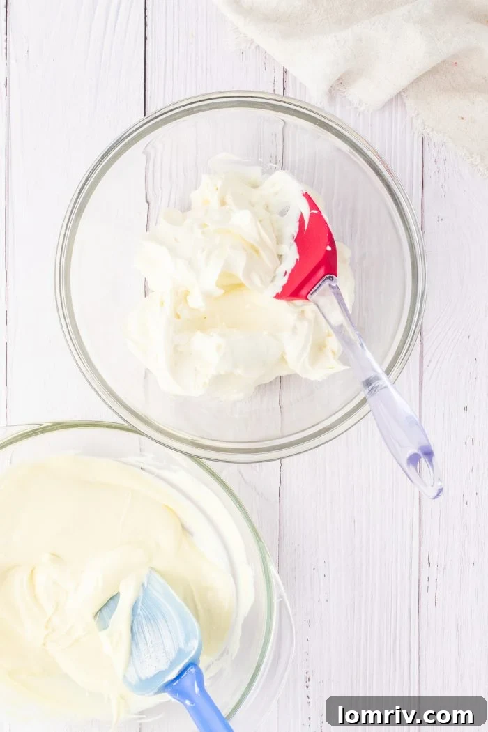 Freshly whipped cream, light and fluffy with distinct peaks, sits gracefully in a clear glass bowl, ready to be gently folded into the cheesecake mixture.
