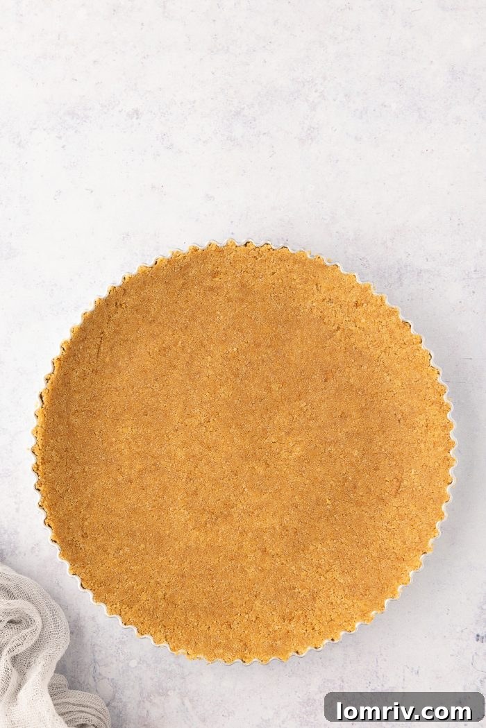 Graham cracker crumbs firmly pressed into the bottom and up the sides of a tart pan.