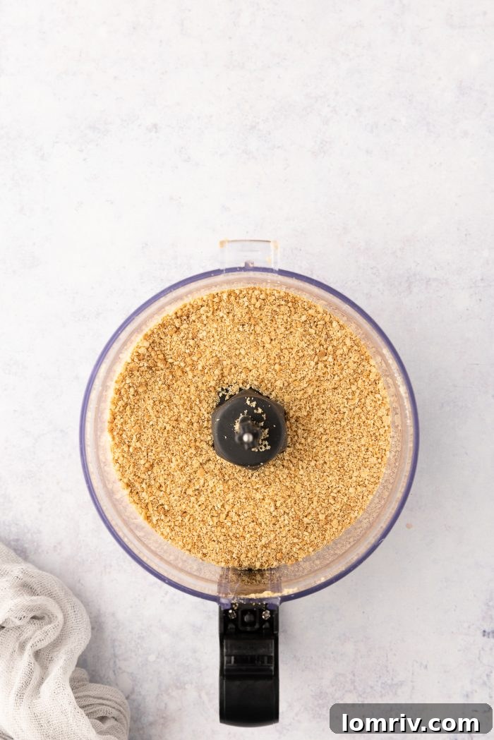 Graham cracker crumbs being processed in a food processor.