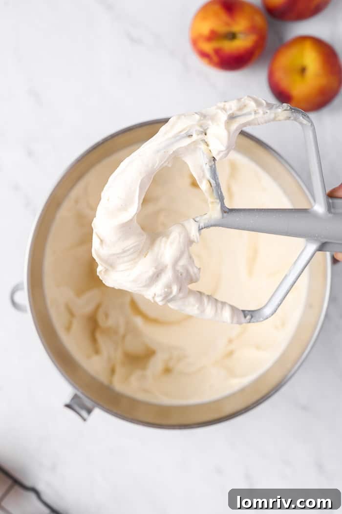 Whipping brown butter buttercream frosting in an electric mixer