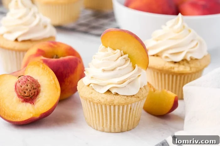 Close-up of fluffy brown butter peach cupcakes topped with whipped brown butter buttercream
