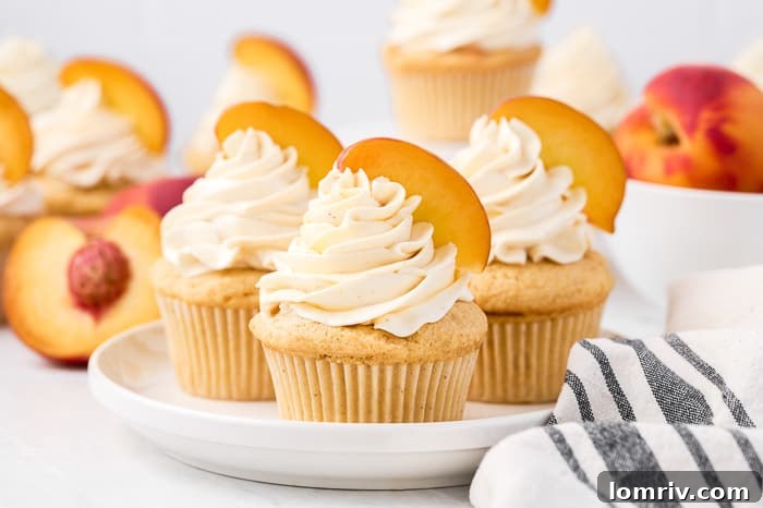 Close-up of a brown butter peach cupcake, showing the cake texture and frosting details
