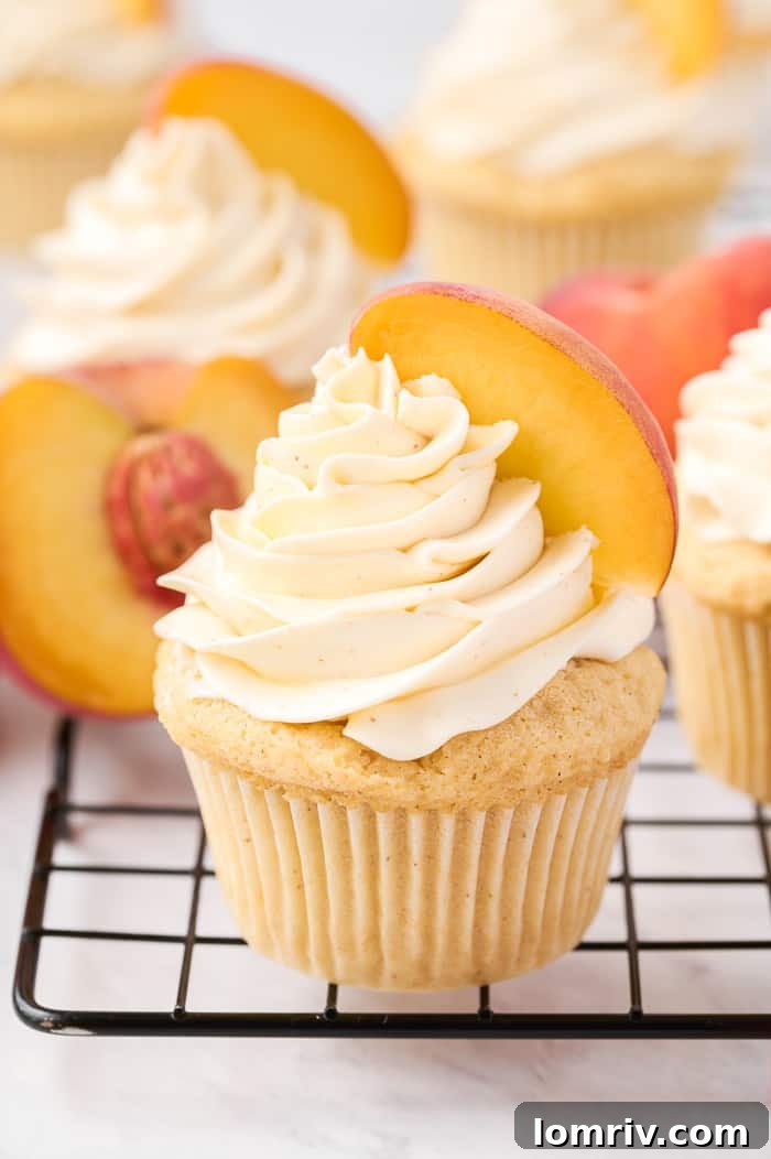 A collection of brown butter peach cupcakes beautifully arranged, showcasing the perfect frosting swirls