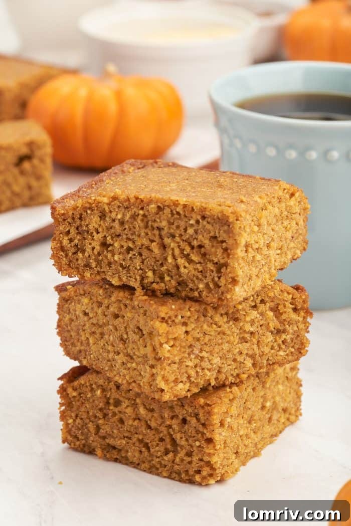 A stack of three slices of pumpkin cornbread.