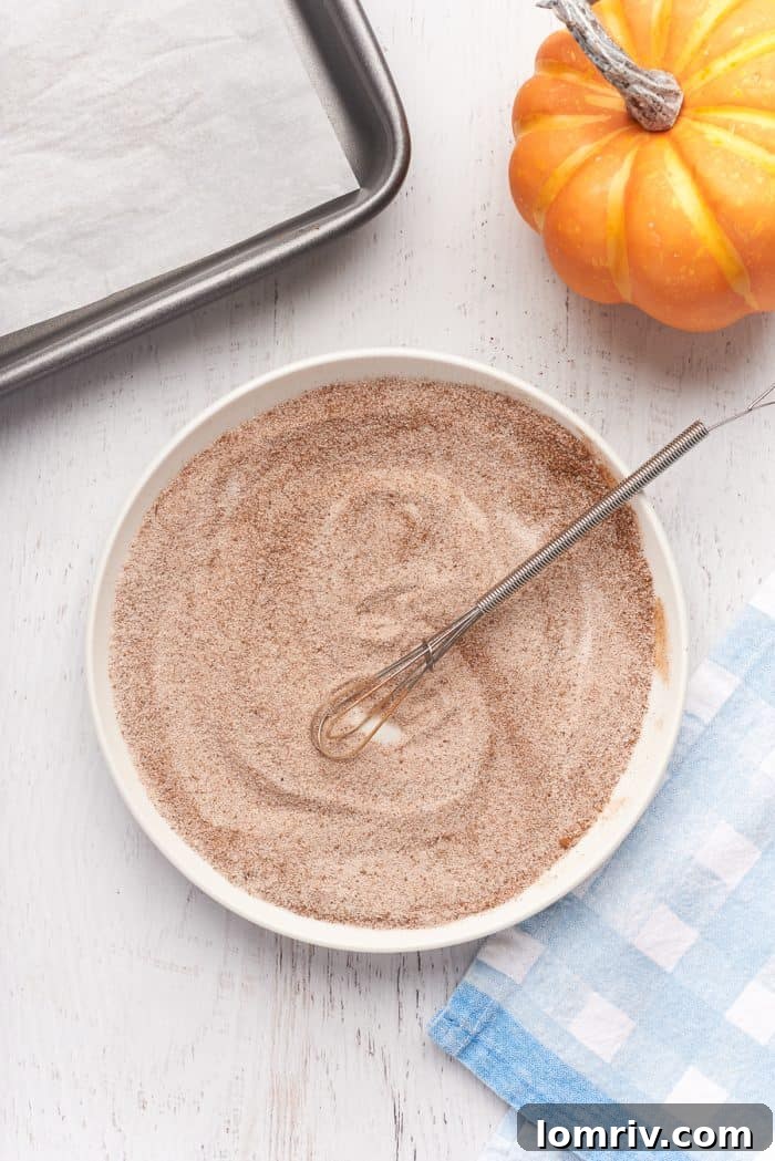 A shallow dish with sugar and cinnamon.