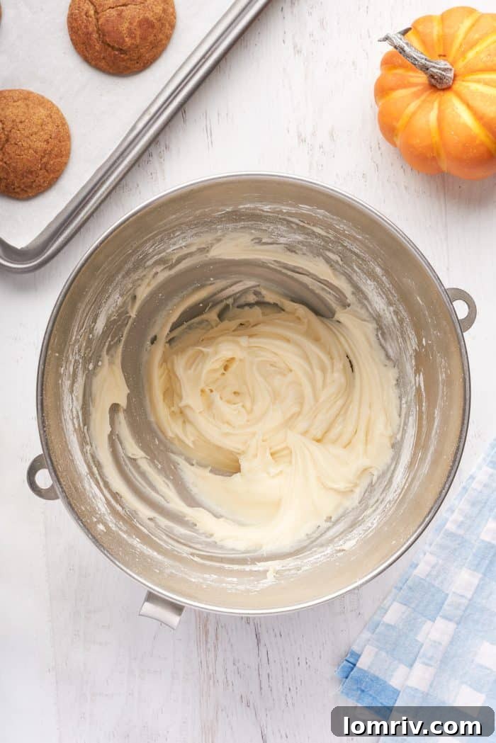 A mixing bowl with cream cheese icing.