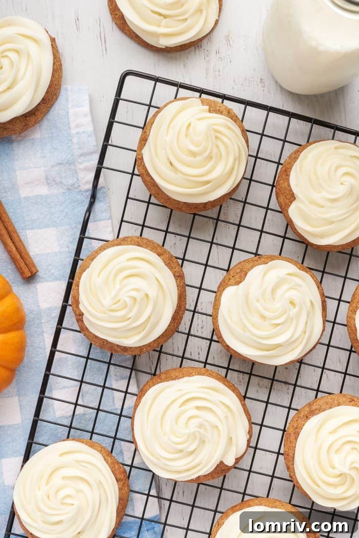A cooling rack with frosted pumpkin snickerdoodles.