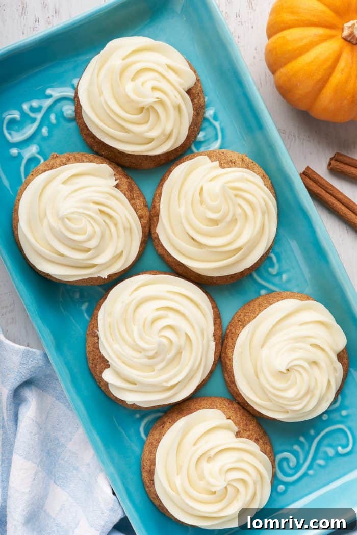 A blue plate with six pumpkin snickerdoodles with cream cheese frosting.