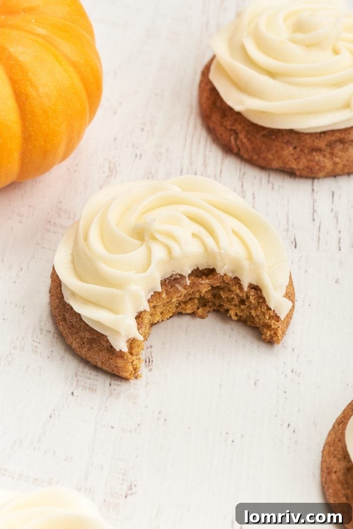 A closeup of a pumpkin snickerdoodle with cream cheese frosting. 
