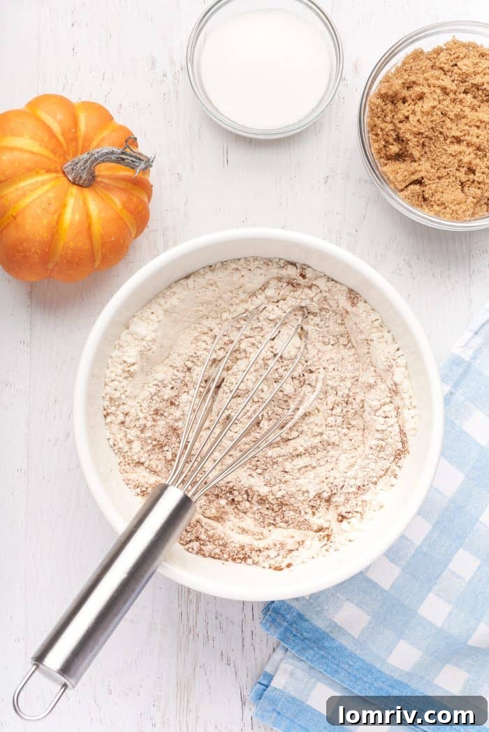 A white bowl with flour and pumpkin spice.
