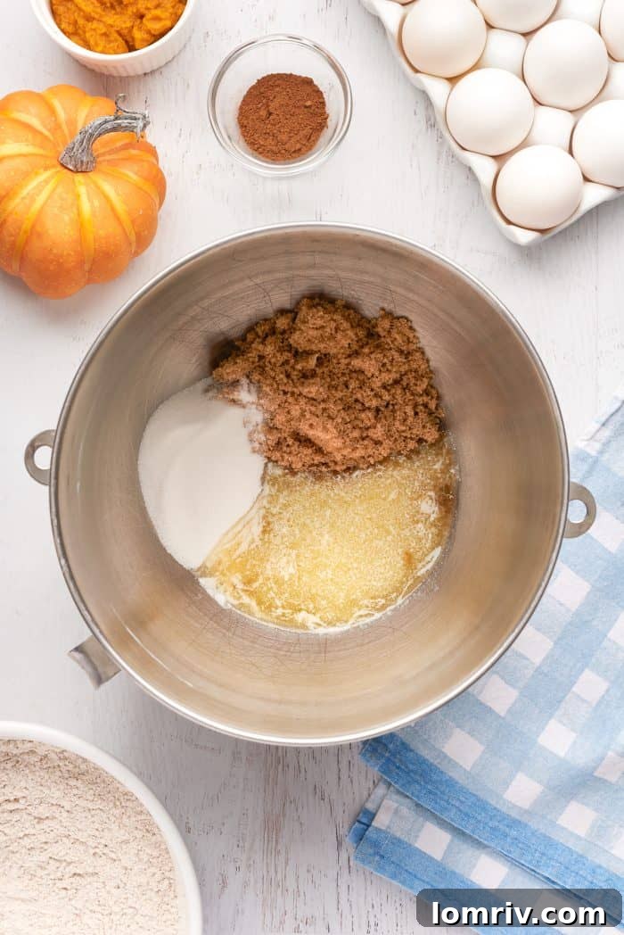 A mixing bowl with brown sugar, sugar, and melted butter.