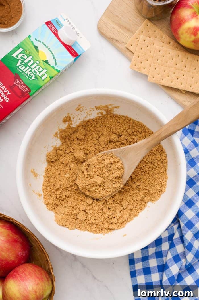 A bowl filled with finely crushed graham cracker crumbs, ready for making the cheesecake crust.