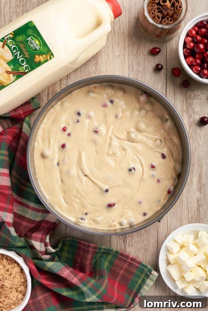 The smooth coffee cake batter evenly spread in a round cake pan, ready for the crumble topping.