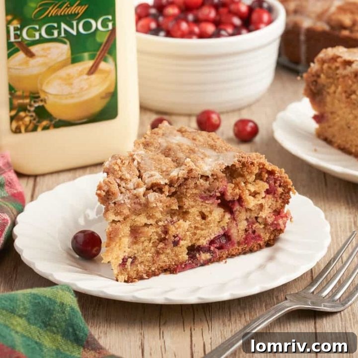 A slice of cranberry eggnog coffee cake on a white plate.