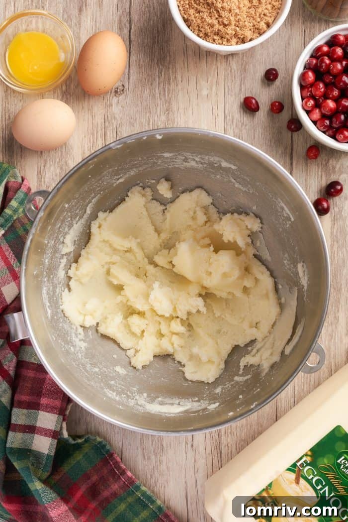 Softened unsalted butter being creamed in a stand mixer, demonstrating the first step in creating a light and fluffy cake batter.