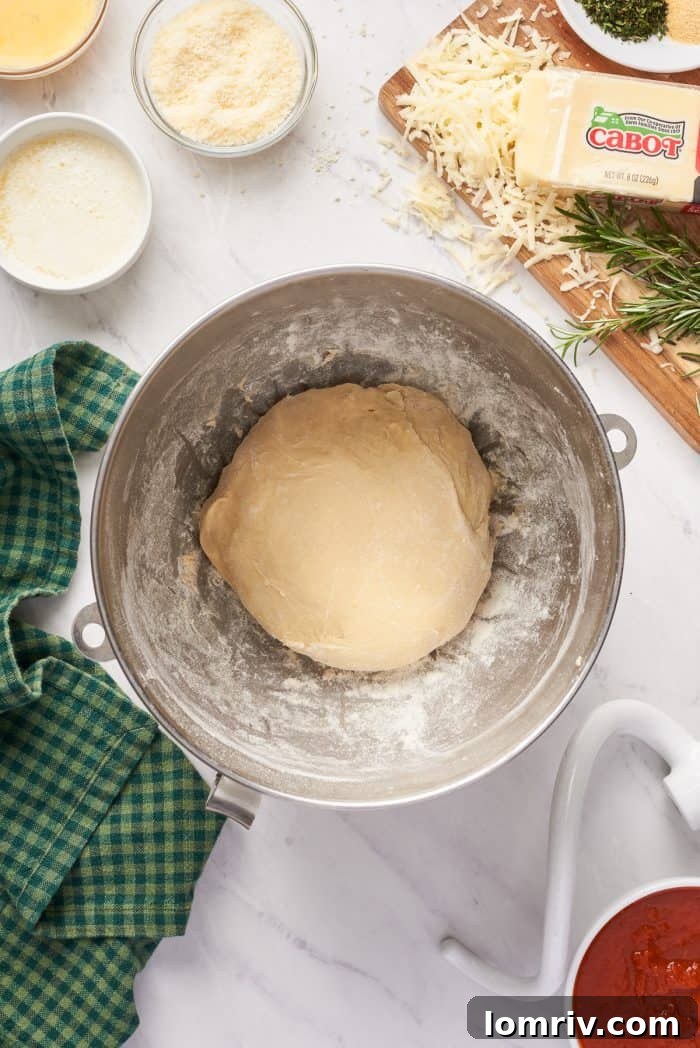 The smooth, pliable dough, beautifully formed and resting in a mixing bowl, ready for its first rise.