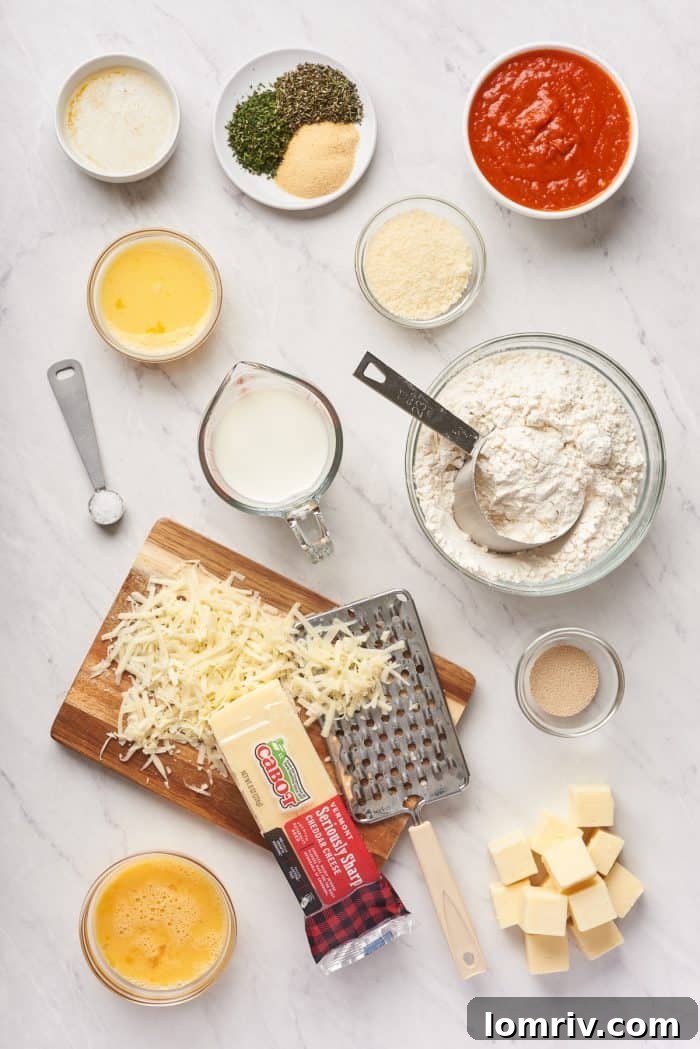 A rustic wooden board displays all the fresh ingredients needed for the Christmas tree pull-apart bread, including shredded cheese and aromatic herbs.