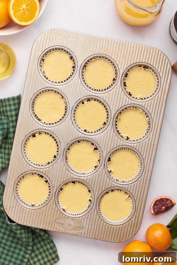 An unbaked tray of cupcakes, neatly filled with batter in their liners, awaiting their transformation in the oven.