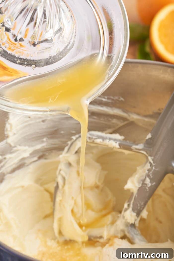 A close-up shot of the blood orange cheesecake batter being mixed in a bowl, showcasing its smooth consistency.