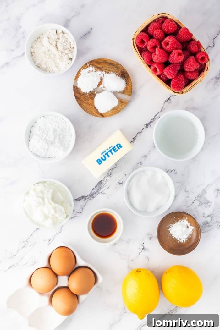 A collection of fresh ingredients laid out for making the lemon raspberry bundt cake.