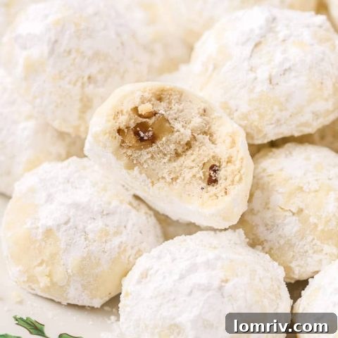 Delicate snowball cookies, also known as Mexican Wedding Cakes, coated in a thick layer of powdered sugar.