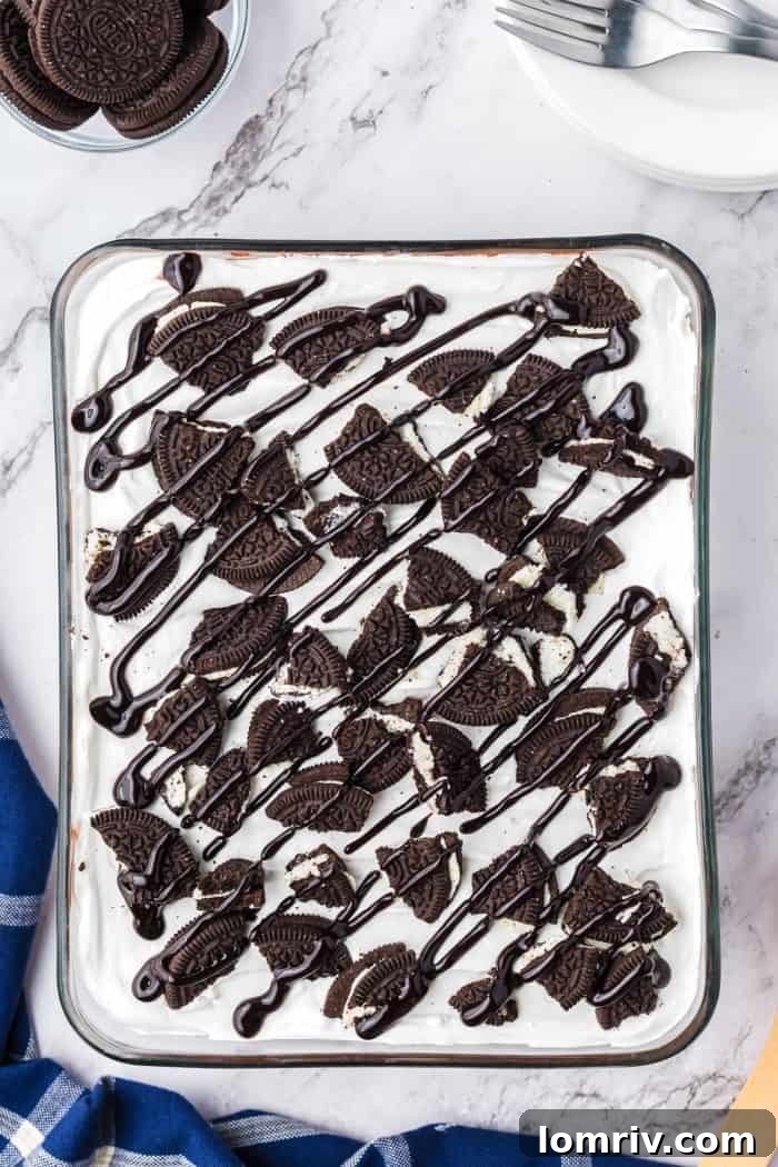 A glass dish filled with no bake Oreo layered dessert.