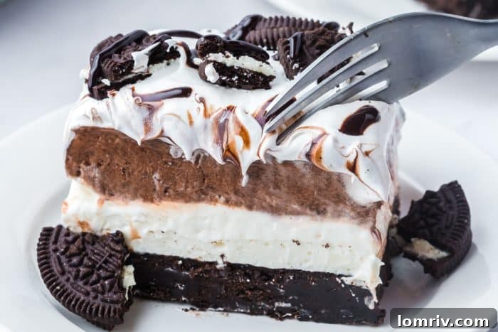 A close up of the Oreo layered dessert with a fork going into it.