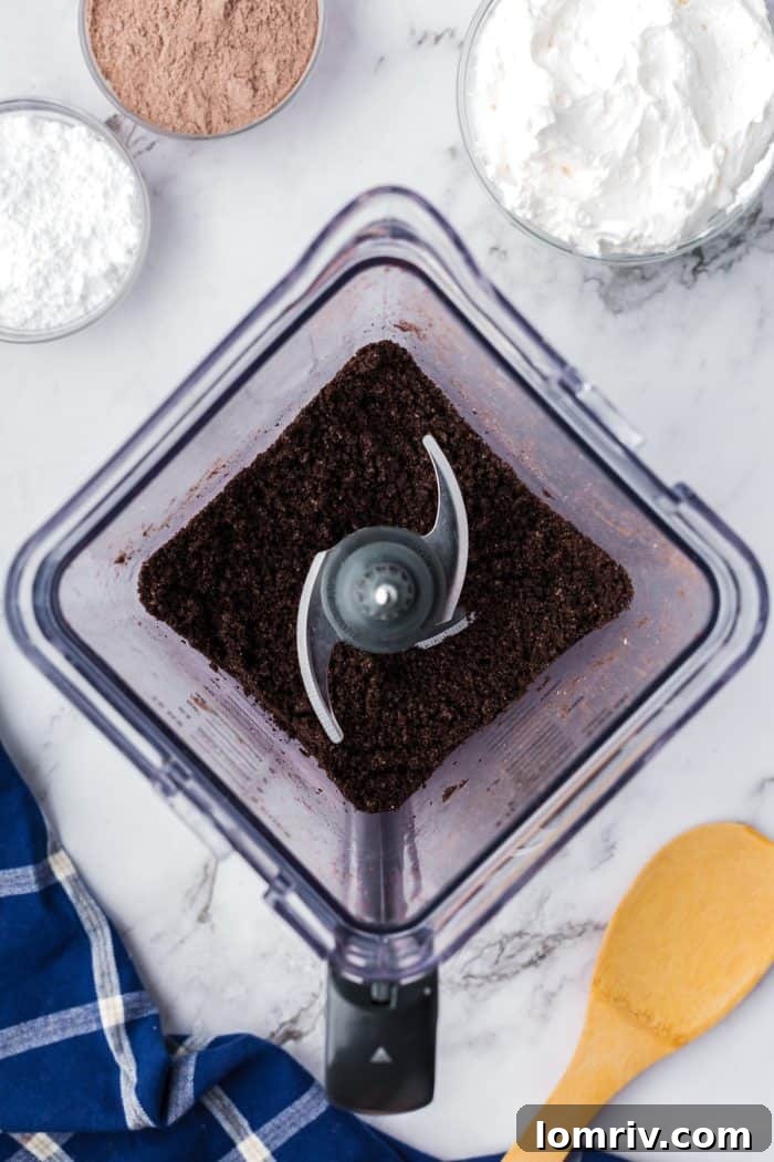 A blender with Oreo crumbs.