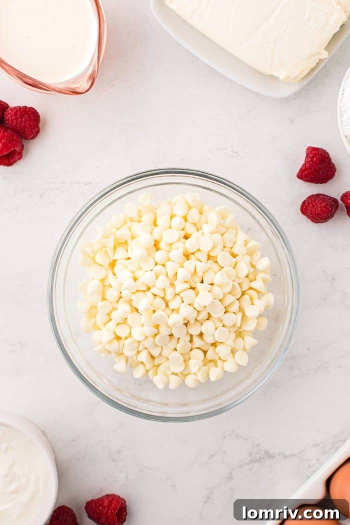 A glass bowl filled with gleaming white chocolate chips, waiting to be transformed into a smooth ganache.