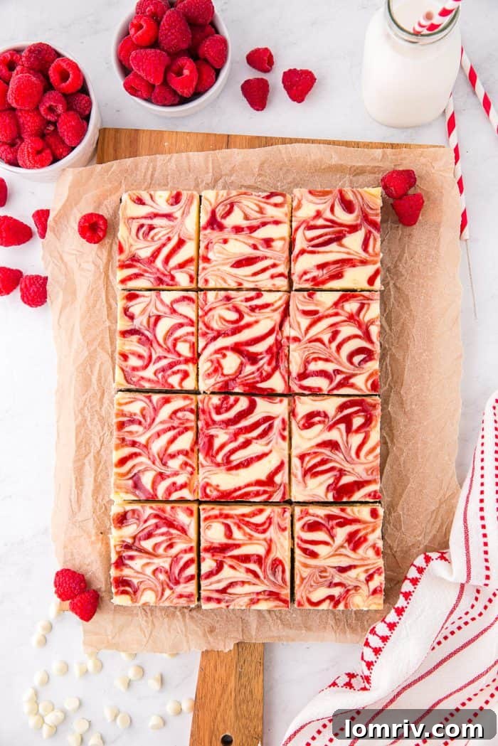 Freshly baked cheesecake bars, cut into perfect squares, showcasing their delicious layers and readiness for enjoyment.