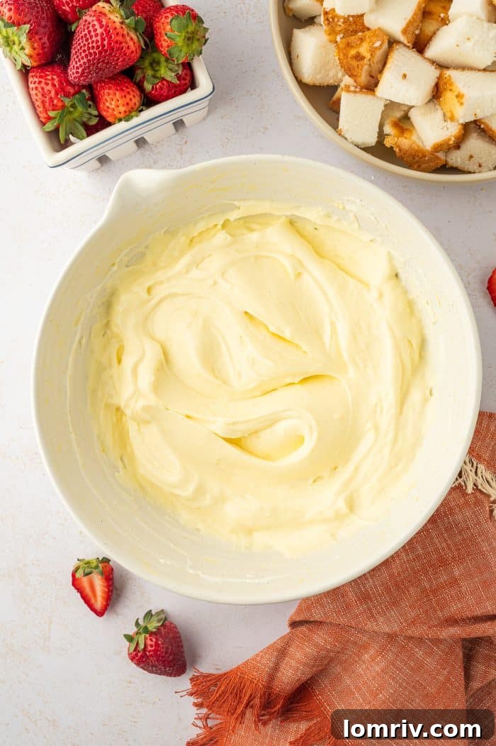 A close-up of the perfectly combined whipped cream and pudding mixture in a bowl, smooth and ready for layering.