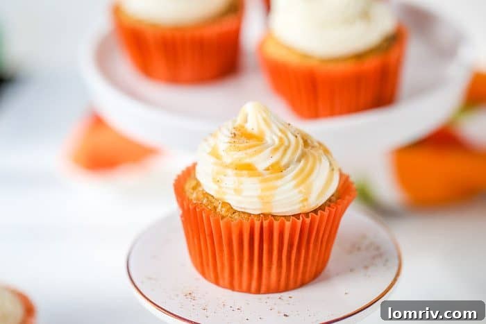Close-up of freshly baked pumpkin cupcakes, golden brown and perfectly risen, cooling on a rack.