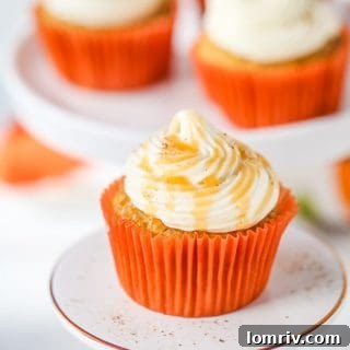 Beautifully decorated Pumpkin Spice Cupcakes with Caramel Cream Cheese Frosting