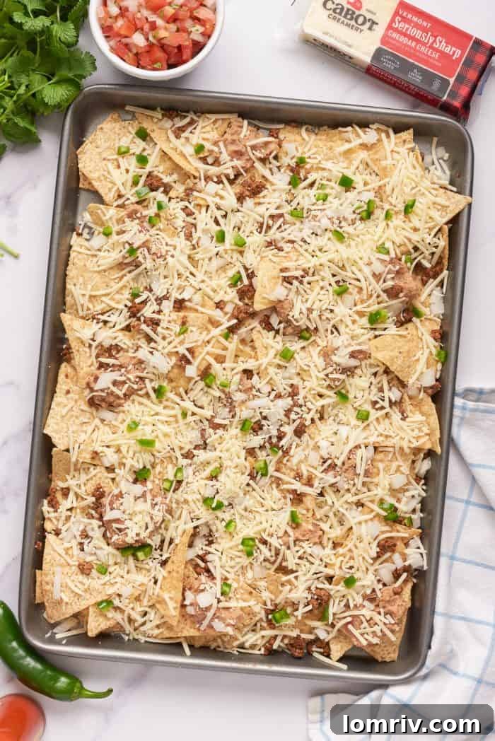 Tortilla chips with a layer of ground beef, refried beans, cheese, and jalapeno peppers.