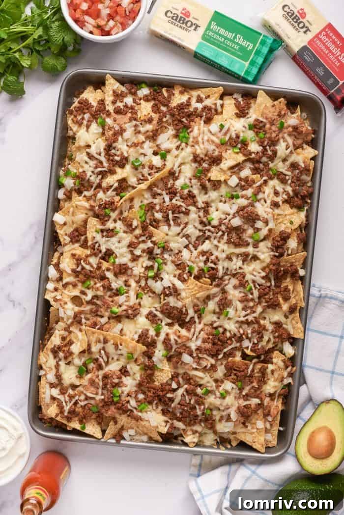 Tortilla chips with a layer of ground beef, refried beans, and cheese baked until the cheese is melted.