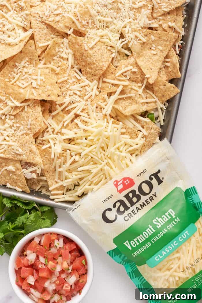 Tortilla chips with shredded Cabot cheese sprinkled over them.