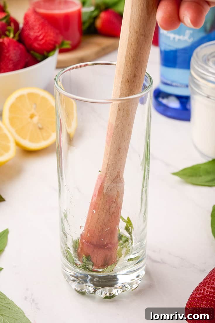 Adding strawberry syrup and vodka to the glass