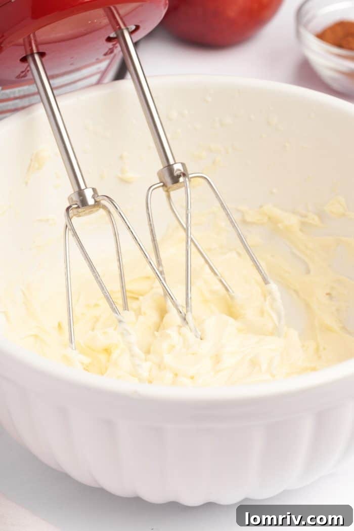 A white bowl of mascarpone being whipped.