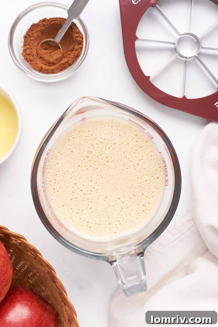 The crepe batter in a large glass measuring cup.