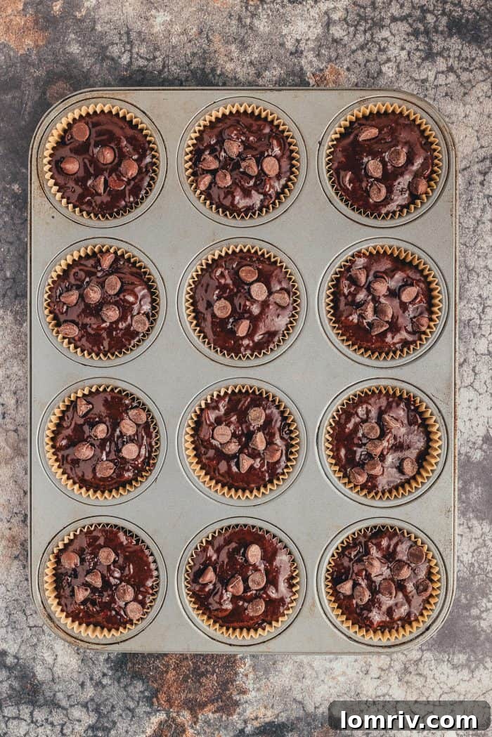 A muffin pan filled with unbaked double chocolate muffins.