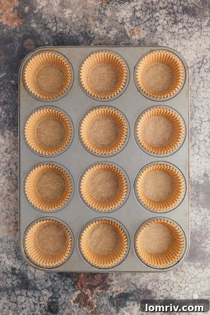 A muffin pan filled with muffin liners.