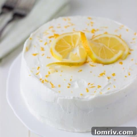 A delicate Meyer lemon cake topped with a light and airy white chocolate mousse, offering a sophisticated flavor profile.