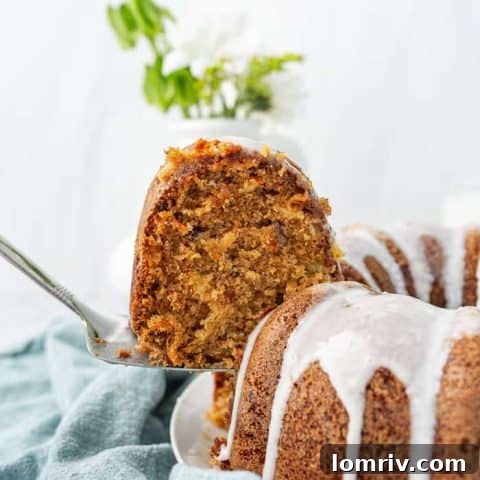 A moist and spiced carrot bundt cake, drizzled with a sweet glaze, featuring a perfect bundt crumb.