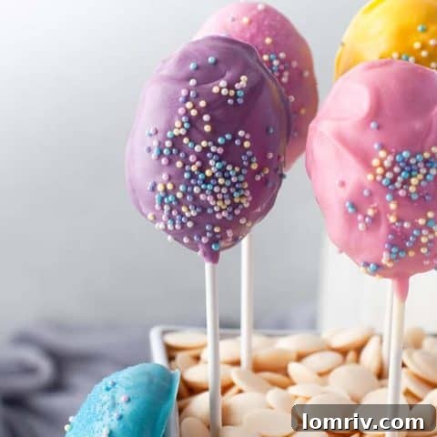 Colorful Easter cake pops dipped in pastel candy melts, adorned with spring sprinkles, perfect for a kids' party.