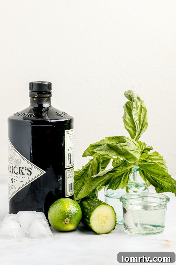 All the fresh ingredients meticulously arranged to prepare a delicious Cucumber Basil Gimlet, including cucumber, basil, lime, gin, and simple syrup.